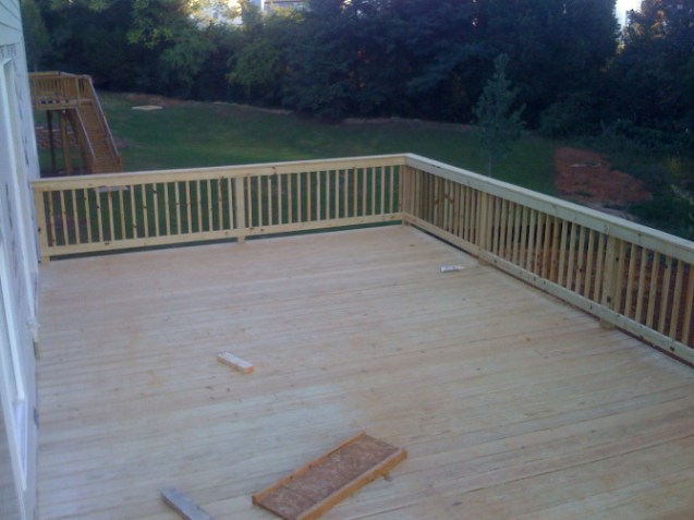 Pressure treated deck with handrail